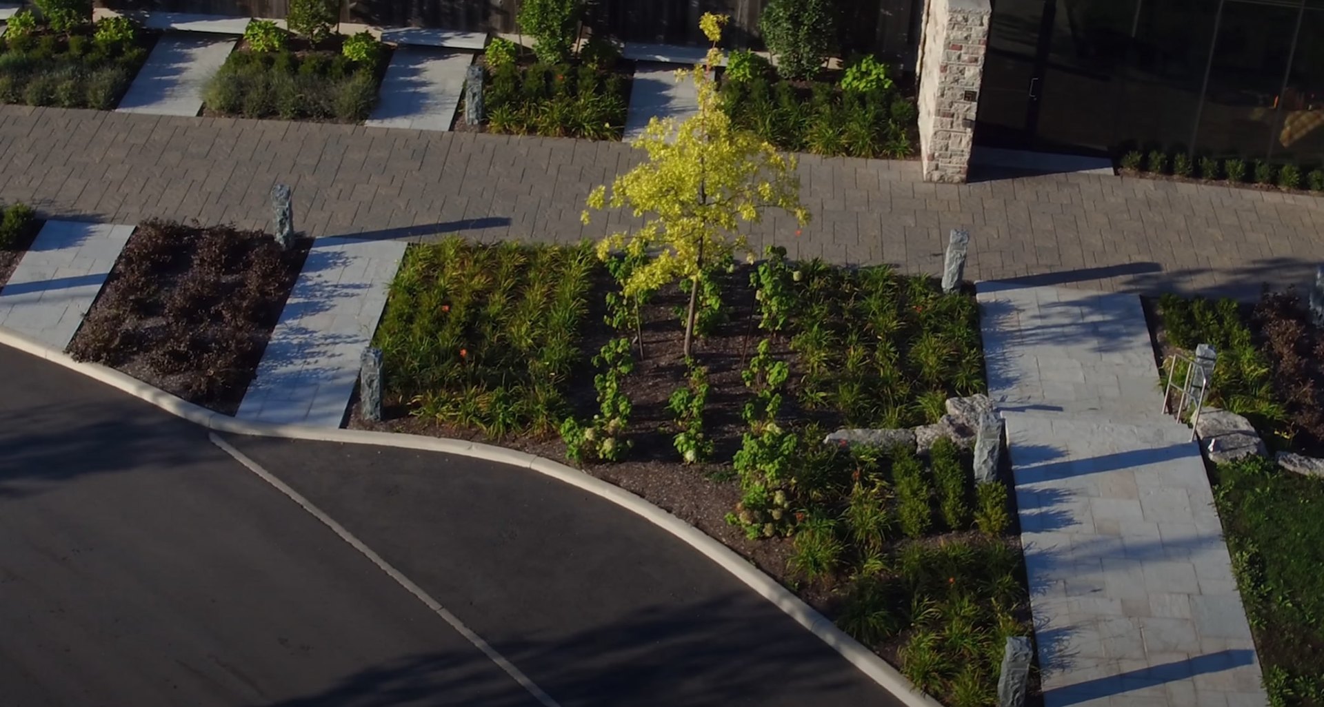 Aerial view of beautifully maintained commercial landscape with clean walkways and manicured plantings