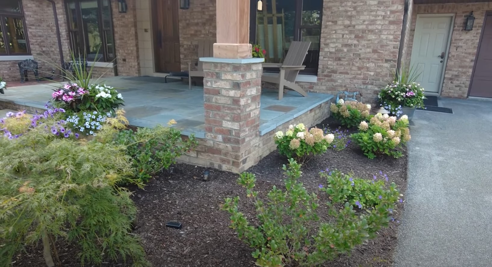 Custom patio design with brick columns and professional landscaping Modern patio with brick columns and landscaping
